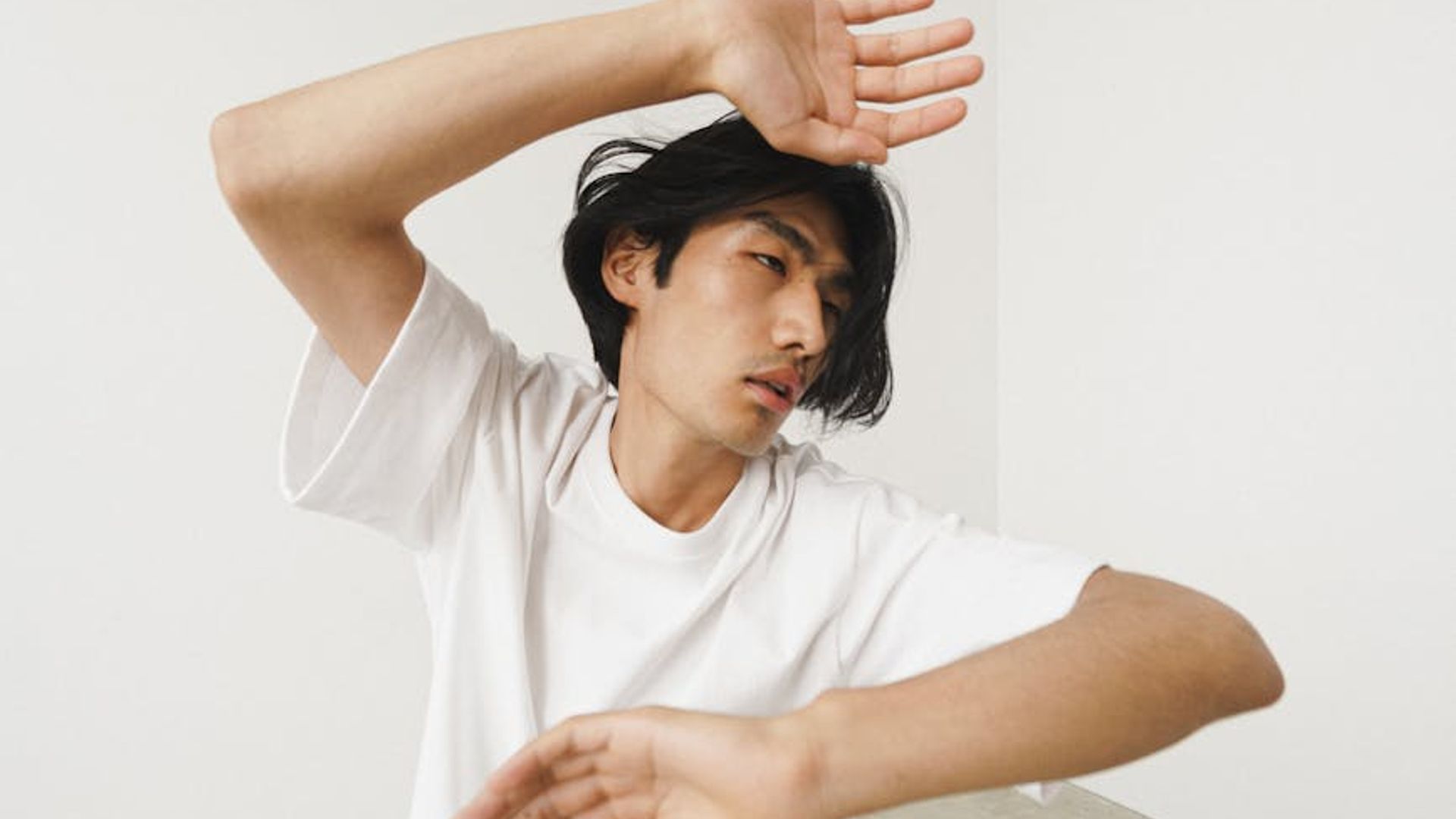 Person in a dynamic cardio pose in a minimalist, modern space.